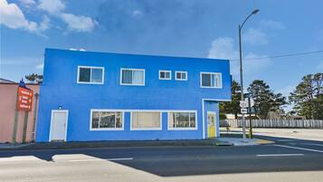 A two-story building with a blue exterior and white windows.