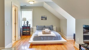 A bedroom with a bed, a dresser, a television, and a painting on the wall. - 4 Mi to Dtwn: Simplistic Summerville Studio (Summerville)