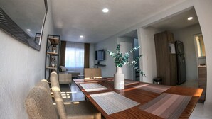 A modern dining area with a wooden table, cushioned chairs, and a large vase. - Beautiful house w heated private pool/ downtown (Tequisquiapan)