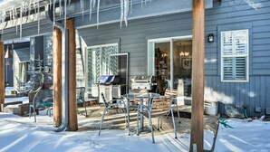 A covered patio with a grill and outdoor seating. - Cozy Vail Valley Townhome - Walk to Riverwalk! (Edwards)