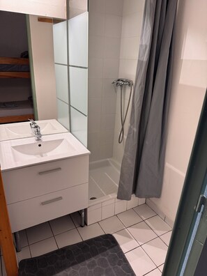 Shower, hair dryer, towels, toilet paper