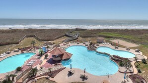 A resort with a large pool area, a beach access point, and a view of the ocean. - Steps To The Sea | Penthouse with Ocean Views (Port Aransas)