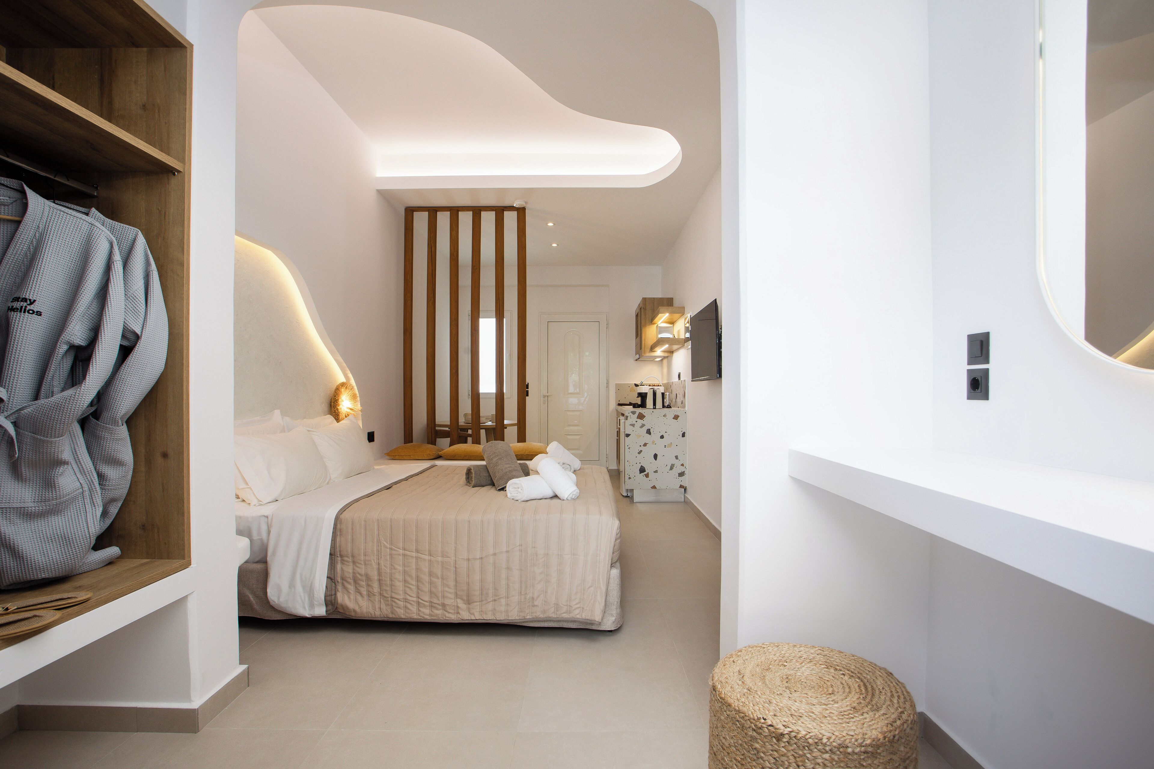 A modern bedroom with a bed, bedside table, and a wardrobe.
