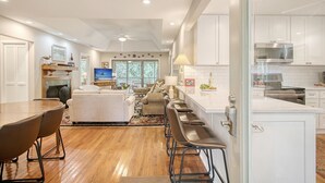 A modern kitchen with white cabinets, a stainless steel microwave, and a built-in oven. - Community pool, dock, river views! (Kiawah Island)