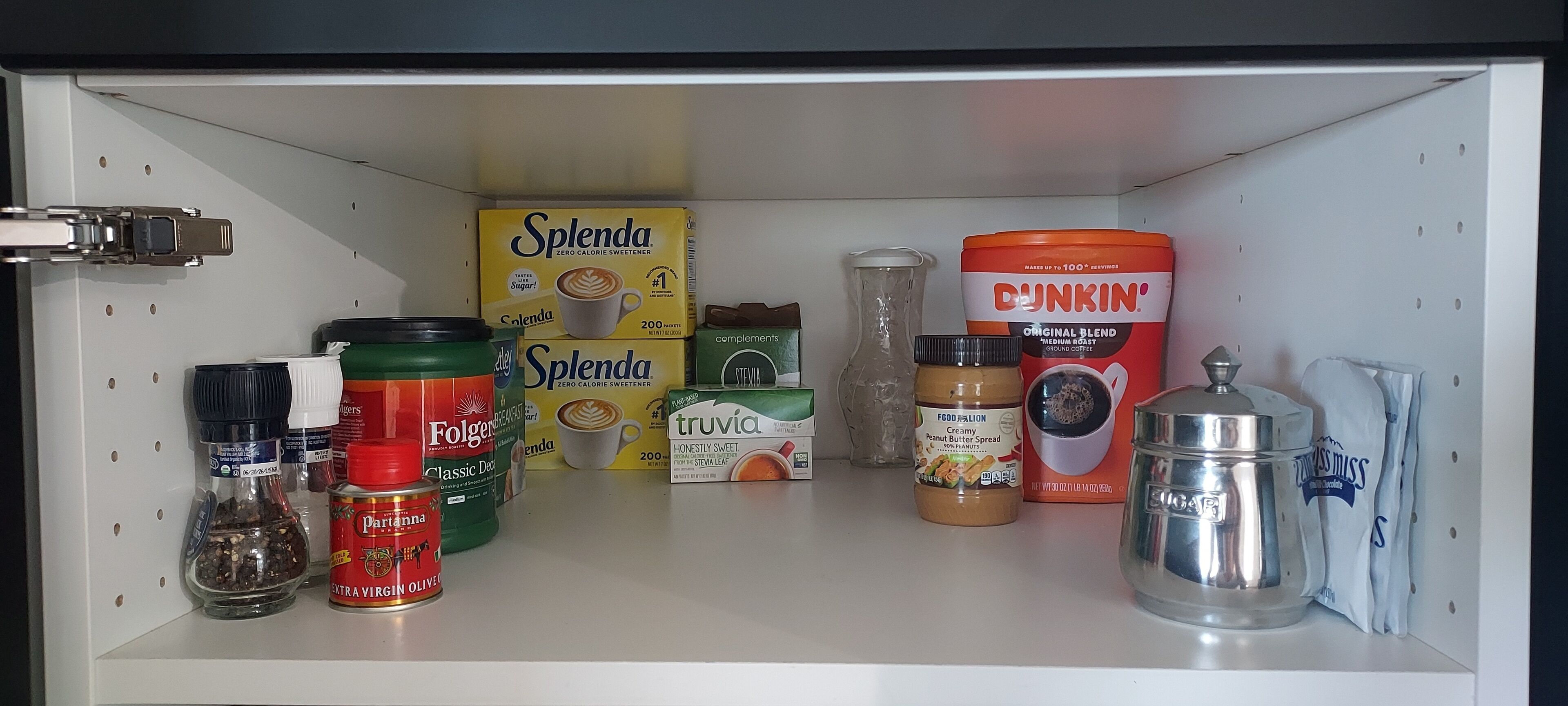 A pantry with various food items including Splenda, Folgers, Truvia, and Dunkin' coffee.