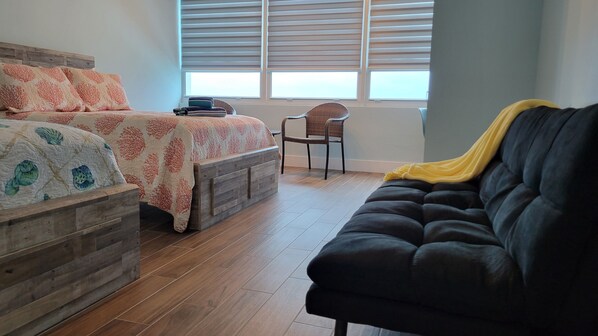 A bedroom with a bed, a chair, a sofa, and a window with blinds. - Amazing ocean view studio 14 floor. Free valet parking. (Miami)