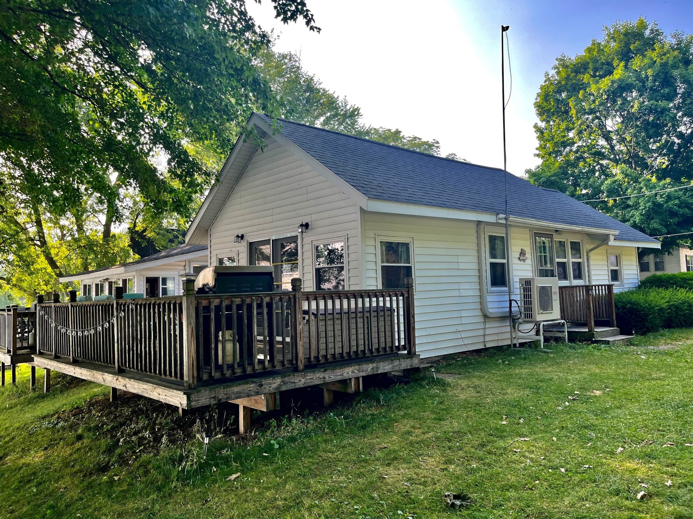 A single-story house with a front deck and a small porch.