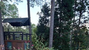 A garden with a wooden deck, a wooden fence, and a gazebo. - Executive Home Gated Golf Community close to Masters! (Aiken)