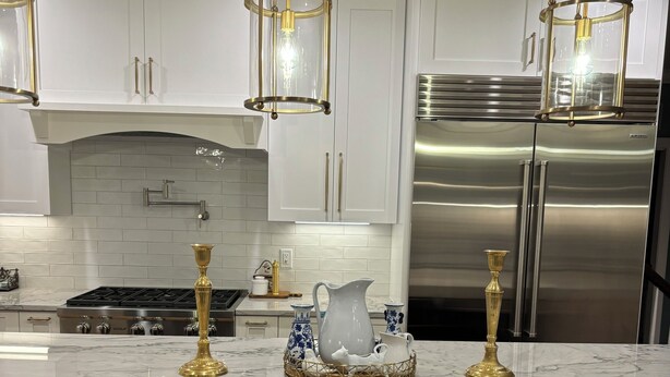 A modern kitchen with white cabinets, a stainless steel refrigerator, and a marble countertop. - Executive Home Gated Golf Community close to Masters! (Aiken)