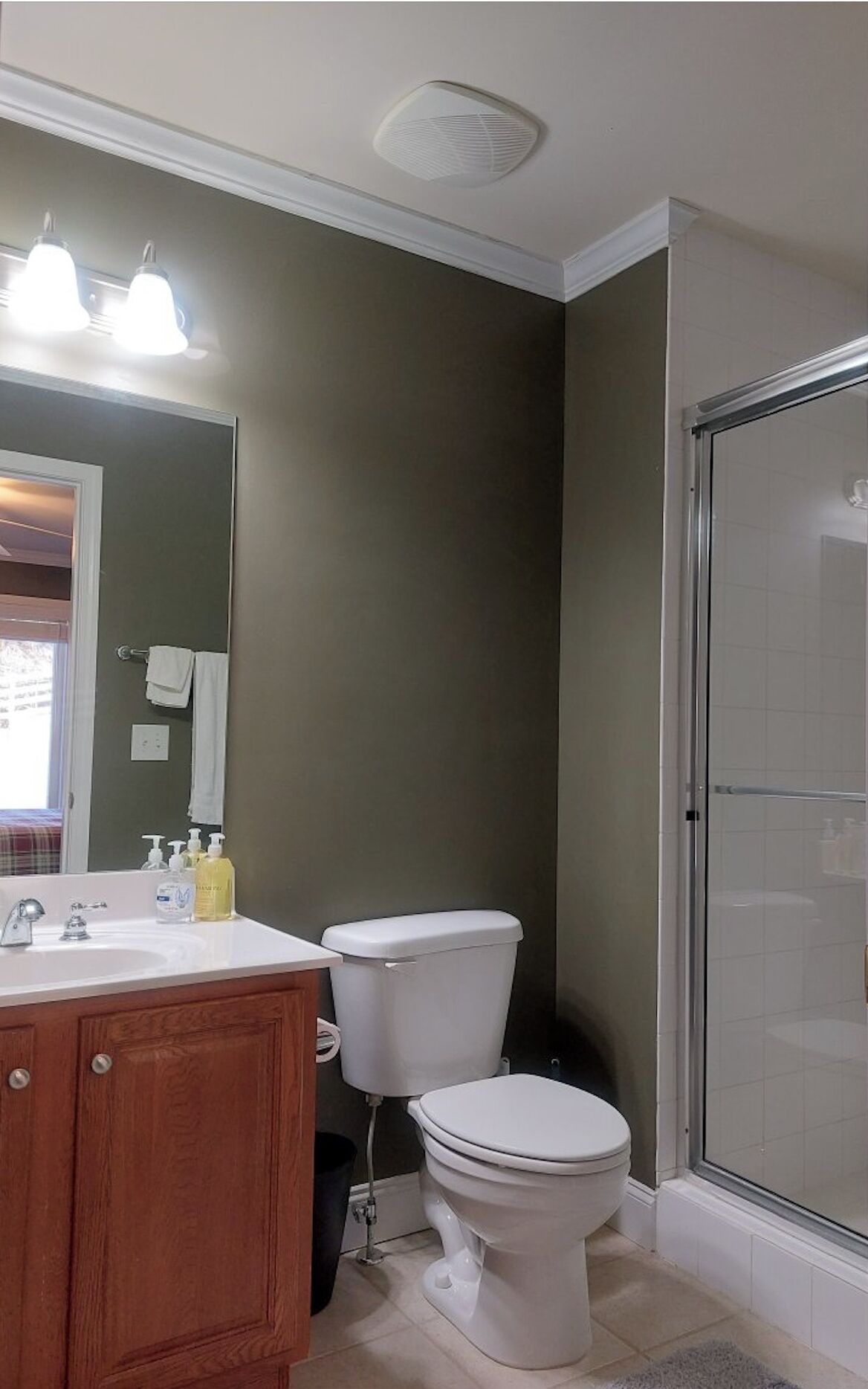 A bathroom with a toilet, sink, and shower.