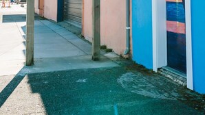 A sign with directions to Tourist Info, Coastal Access, and Lighthouse. - Cozy 2 Bedroom with Full Kitchen One Block from the Ocean!! (Crescent City)