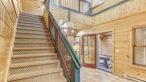 A wooden staircase with a patterned carpet leading to a second floor. - Gorgeous Cabin w/direct trail access for hiking & off roading! (Payson)