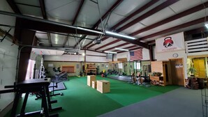 A gym with green flooring, weightlifting equipment, and an American flag. - Iron Wolf nestled in the Sangre de Cristo Mtns...Ski/Hike/Fish/Hunt Casita (Eagle Nest)