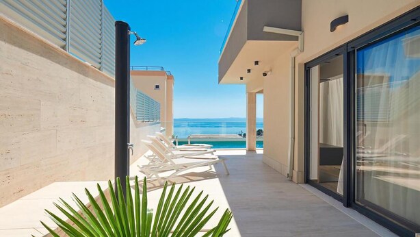 A modern hotel corridor with a pool and ocean view. - Gorgeous home in Makarska with sauna (Makarska)