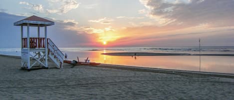 Enjoy a serene beach experience with gentle waves and a lifeguard tower for added safety.