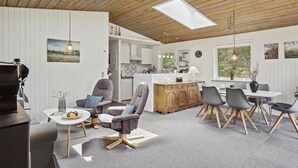 A modern kitchen with white cabinets, a wooden ceiling, and a skylight. - Amazing home in Brovst with kitchen (Brovst)