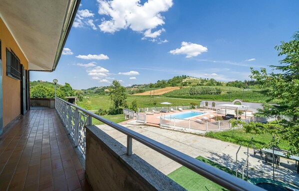 A balcony with a view of a swimming pool, garden, and hilly landscape. - Pet friendly home in Asti with private swimming pool, can be inside or outside (Asti)