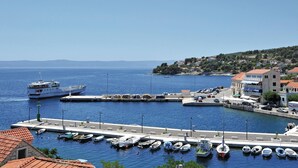 A marina with various boats docked, a large ship in the background, and buildings along the waterfront. - Pet friendly home in Selca (Selca)