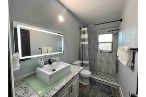 Shower, hair dryer, towels, soap
