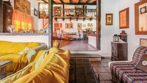 A cozy living room with a sofa, a patterned armchair, and a dining area with a table and chairs. - Pet friendly home in Valverde de Leganés (Valverde de Leganés)