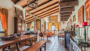 A rustic dining area with wooden benches, a stone-tiled floor, and a staircase leading to an upper level. - Pet friendly home in Valverde de Leganés (Valverde de Leganés)