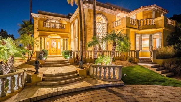 A large, well-lit mansion with a grand entrance, multiple staircases, and a landscaped garden. - Lux Scottsdale/ Carefree family retreat golf pool (Carefree)