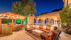 An outdoor patio with a fire pit, seating area, and a bar. - Lux Scottsdale/ Carefree family retreat golf pool (Carefree)