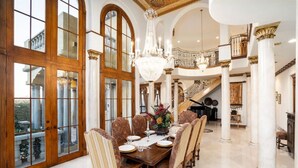 A grand dining room with a long table, ornate chairs, and a chandelier. - Lux Scottsdale/ Carefree family retreat golf pool (Carefree)