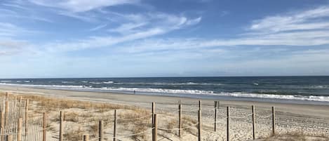 Enjoy a serene beach experience with a designated walking path and calm ocean views.