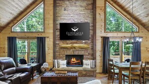 A cozy living room with a fireplace, leather sofas, and a dining area.