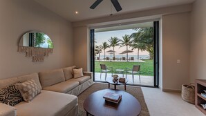 A modern living room with a sofa, coffee table, and a large mirror. - Medusa🌴 Elegant 1BDR Apartment by the Sea | Luxury & Relaxation in Tulum (TULUM)