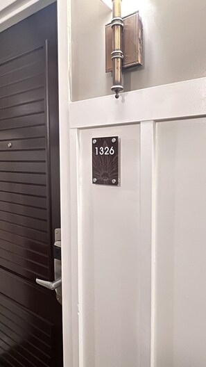 A door with a number plate labeled "1326" and a metallic handle. - Kauai Beach Resort, Top Floor, Pool View (Kauai)
