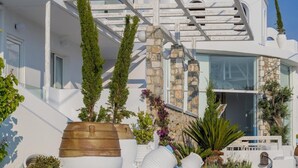 A modern building with a white exterior, a bell tower, and a dome. - Kouros Home and Suites (Rhodes)
