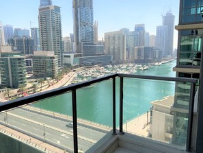 A high-rise building with a view of a marina and cityscape. - 2-BR Marina View Retreat at Marina Quays - DSY (Dubai)