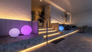 A modern staircase with illuminated steps and decorative spherical lights.