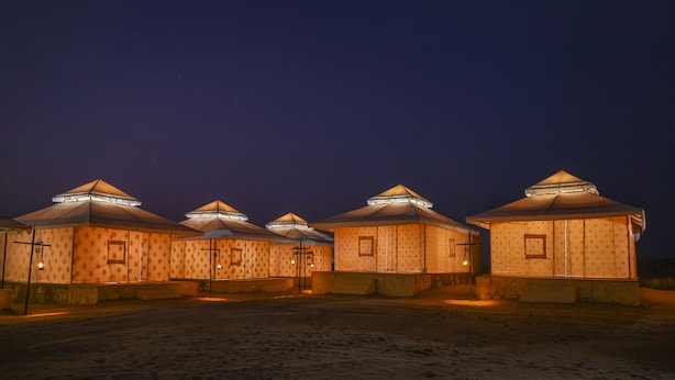A row of small, uniformly designed buildings with a consistent architectural style, likely part of a resort or hotel complex. - The Carvaan Resort (Jaisalmer)