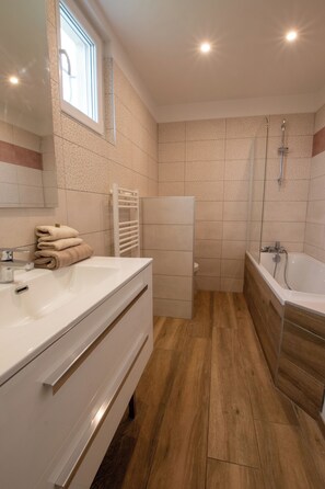Bathtub, hair dryer, towels, soap