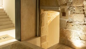 Un mur en pierre à motifs et une colonne en métal.