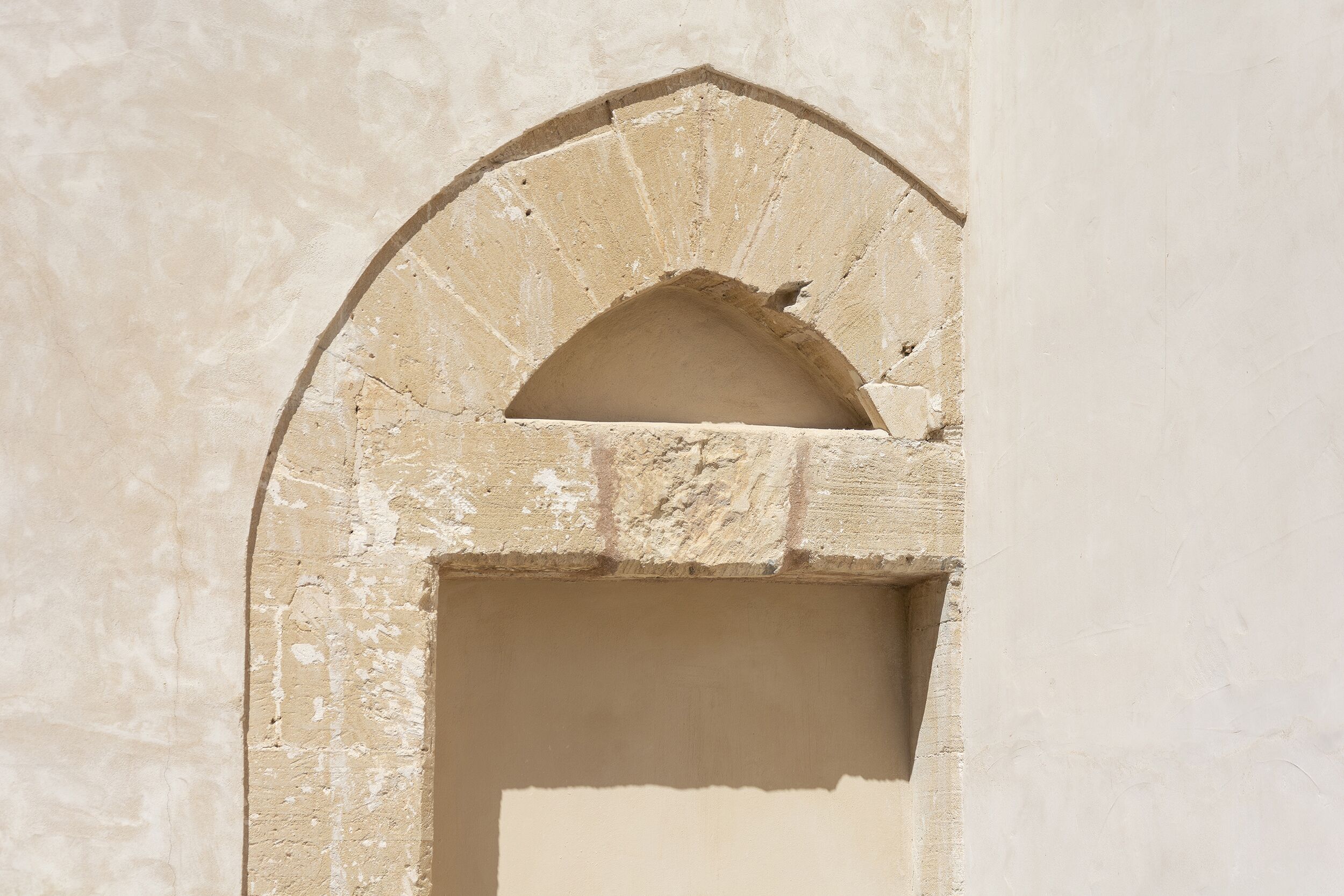 Un arco de piedra con un vano rectangular.