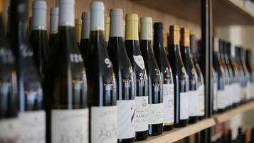 A row of wine bottles on a shelf.
