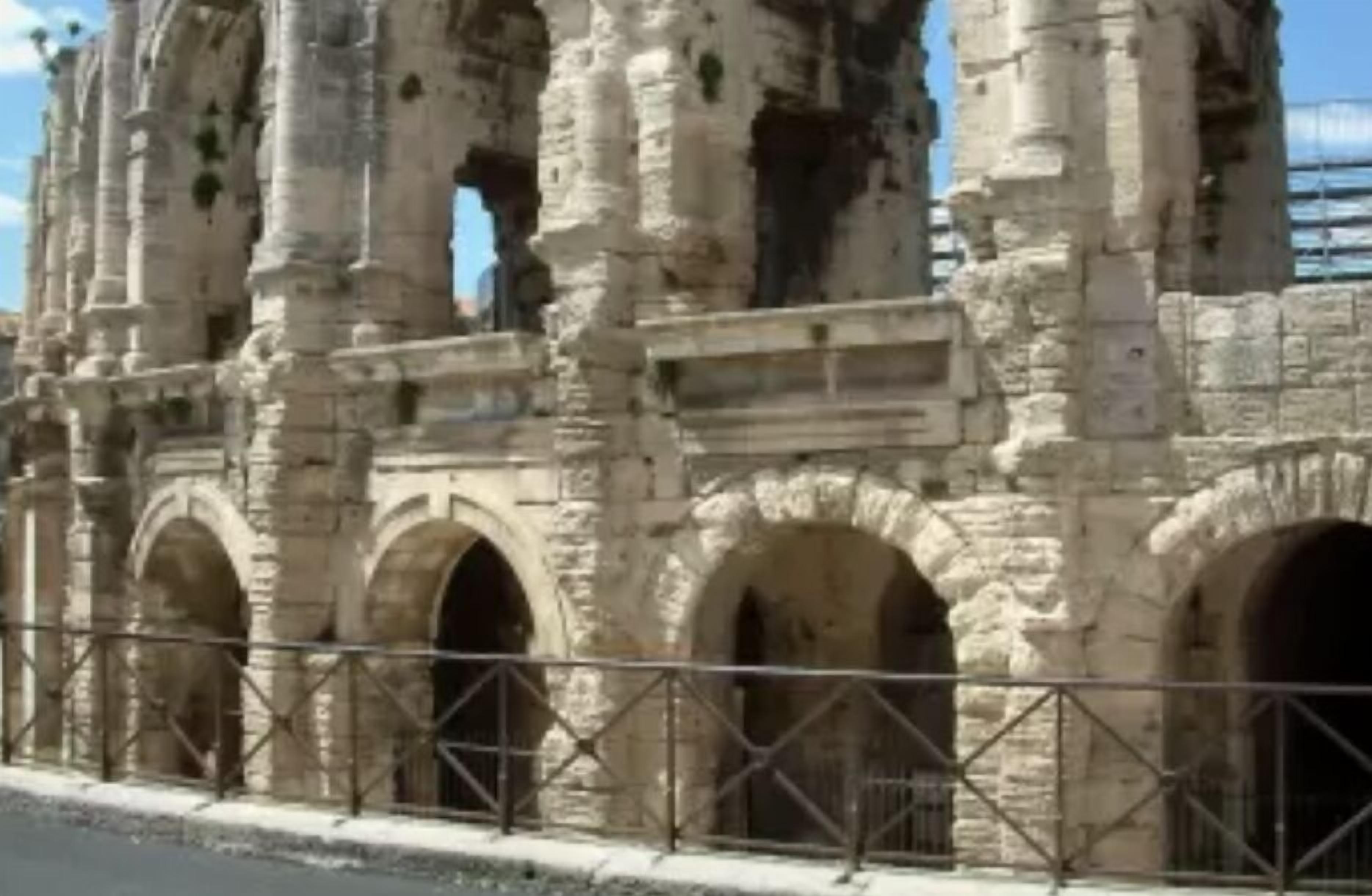 A historic stone structure with arches and columns, likely a ruin or ancient building.