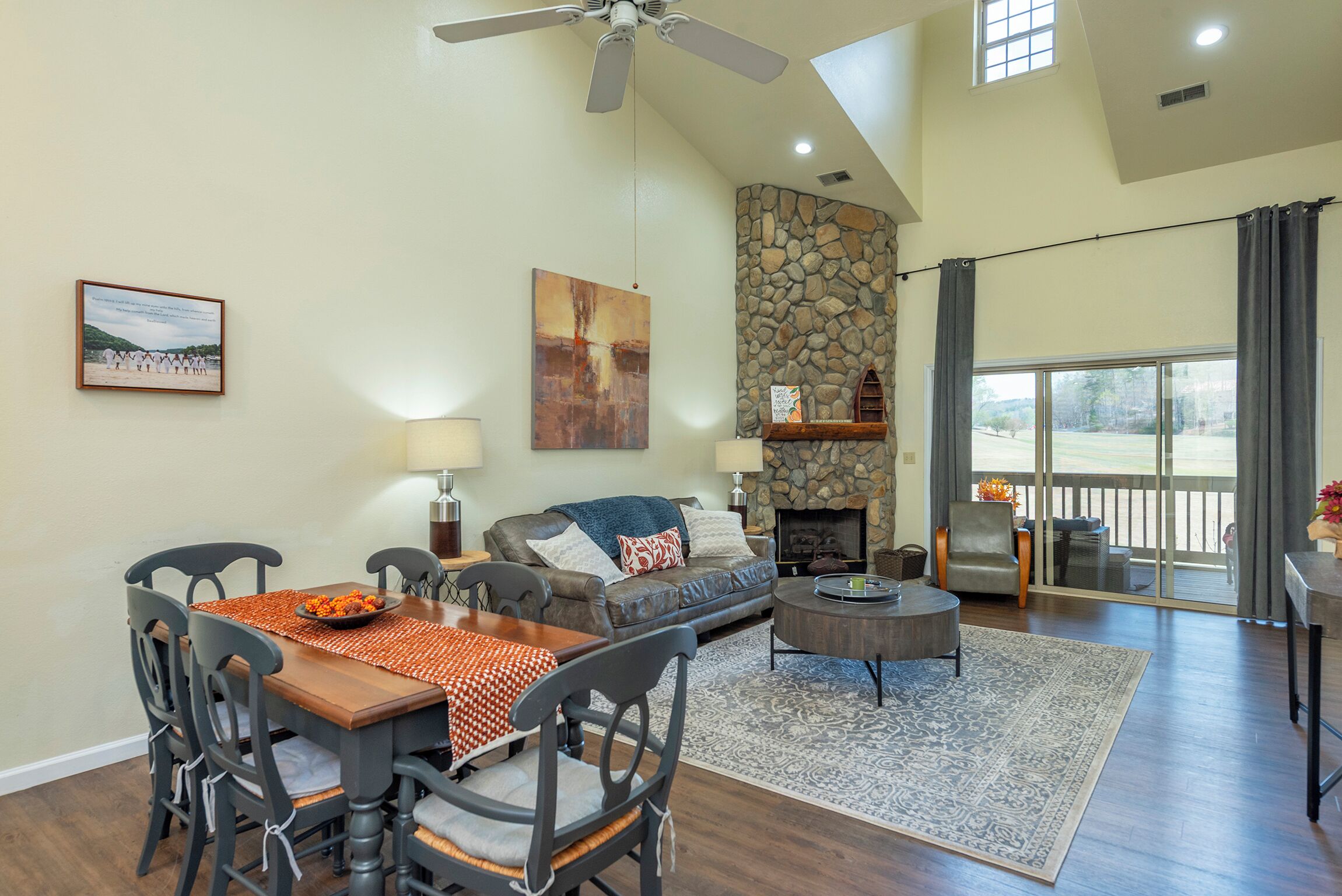 A spacious living area with a fireplace, dining table, and comfortable seating.
