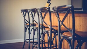 A dining area with four black metal chairs and a wooden table. - WSR-12 Riverfront balcony views. (Wilmington)