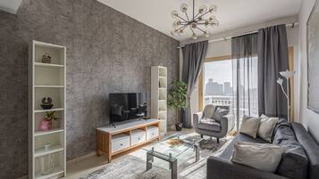 Deluxe Apartment | Living area | 32-inch Smart TV with cable channels, TV, Netflix