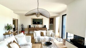 Un salon moderne comprenant un canapé, une table basse et un téléviseur.