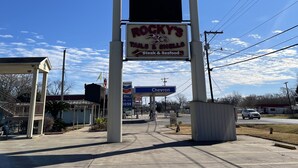 A sign for All Star Inn, Grill Dugout Bar, and Rocky's Tails & Shells.
