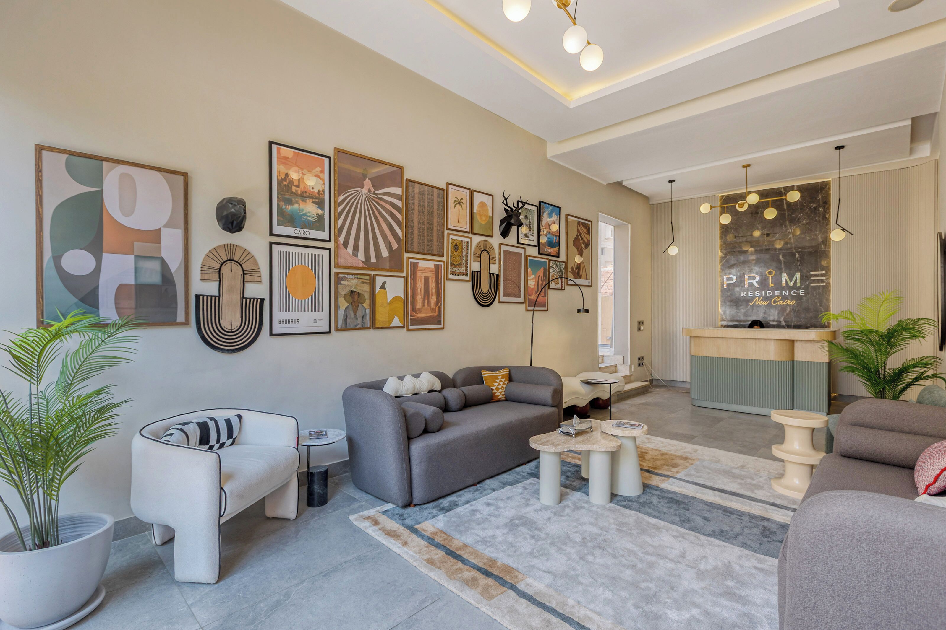 A modern living room with a grey sofa, a coffee table, and a rug.