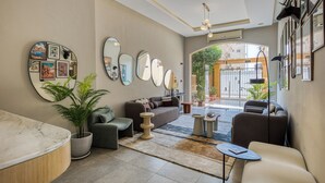 A modern living room with a sofa, coffee table, and potted plants. - Prime Residence New Cairo (New Cairo)