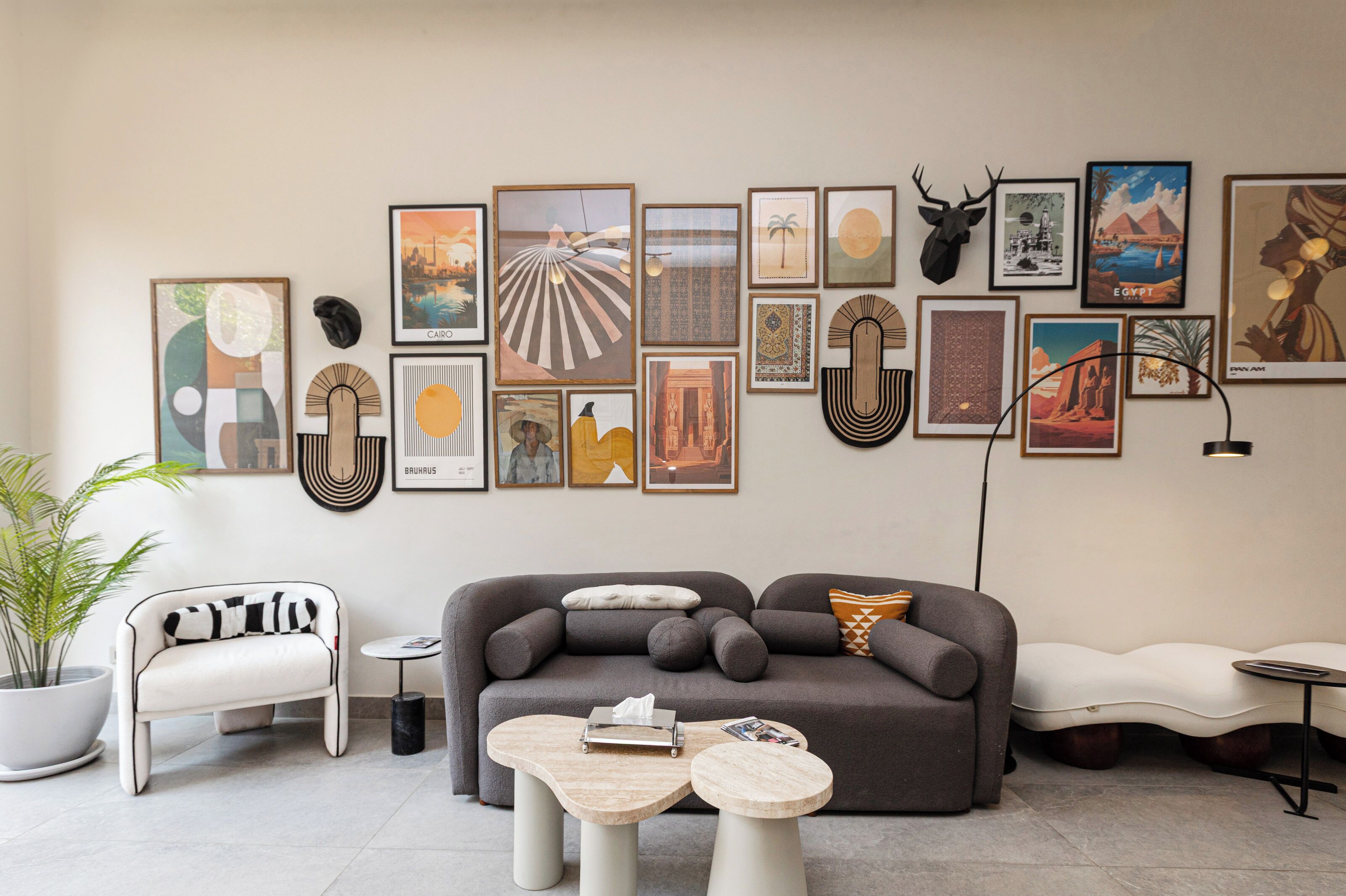 A modern living room with a grey sofa, a white armchair, and a coffee table.