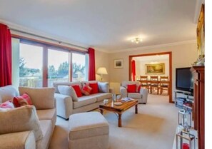 Cozy living space with a sofa, coffee table, and fireplace, perfect for relaxing and socializing.